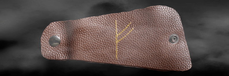 Fehu rune on the skin as an amulet of good luck