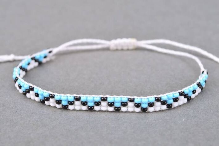 A bracelet made of threads and pearls is a talisman that will bring good luck to the owner